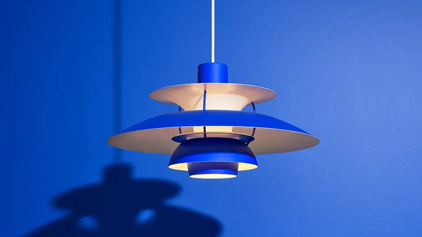 blaue Louis Poulsen PH 5  lampe vor blauem hintergrund